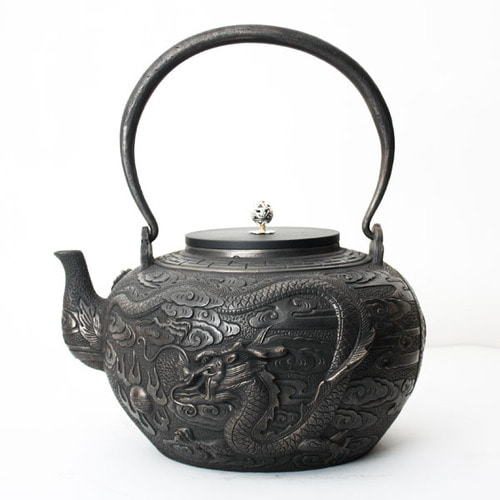 a large dragon-shaped iron kettle